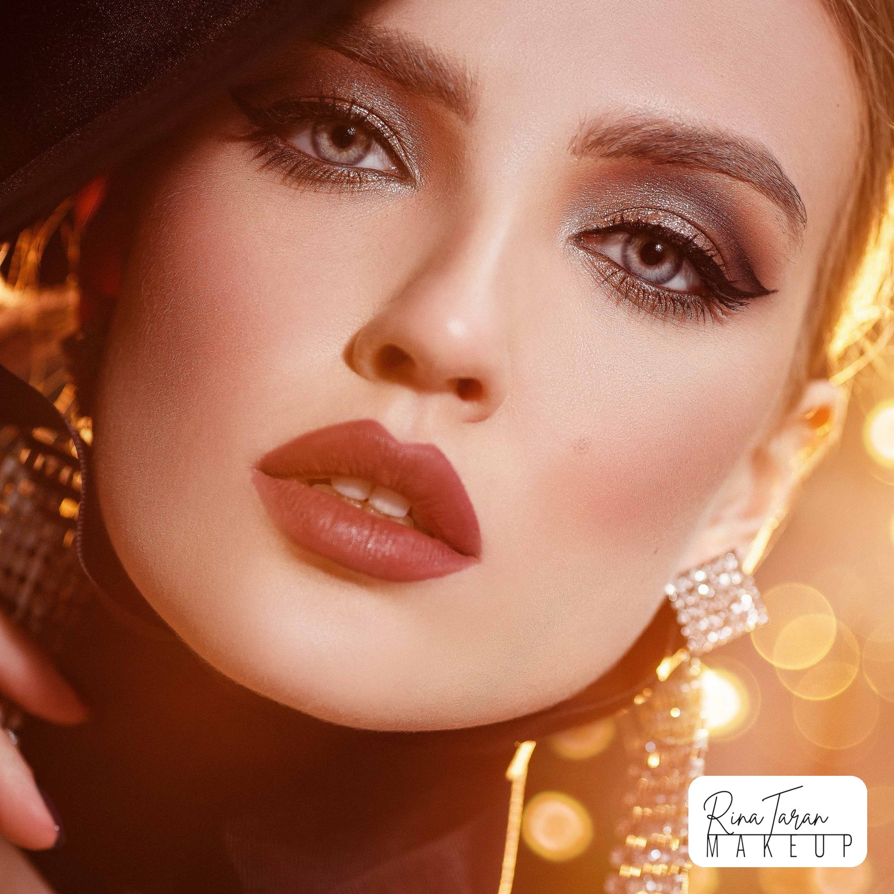 Glam and dramatic makeup with a silver smoky eye and a rose brown lip