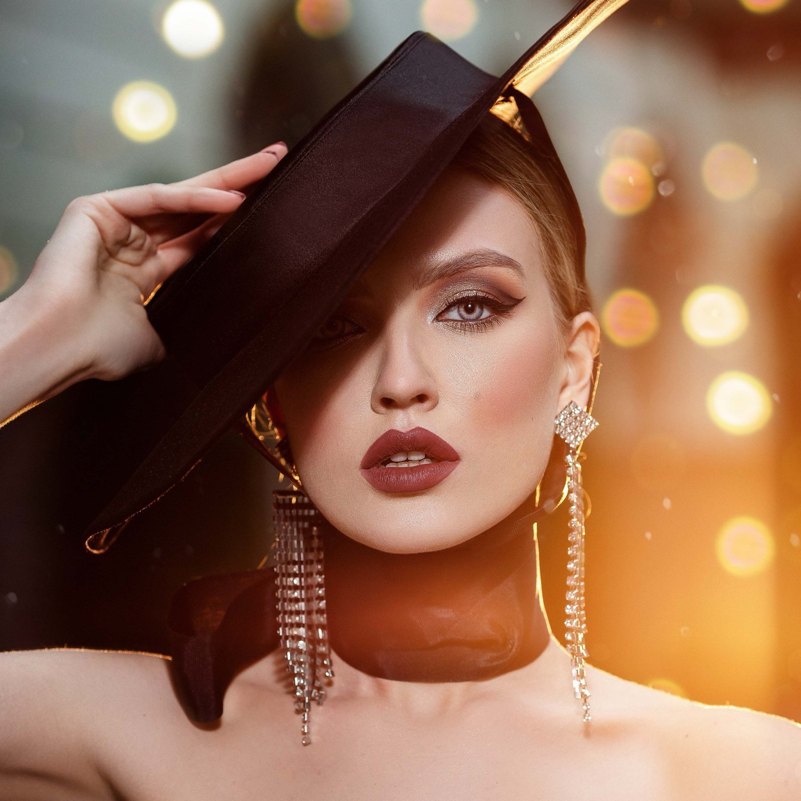 Dramatic editorial makeup with a bold lip and sculpted glam styling